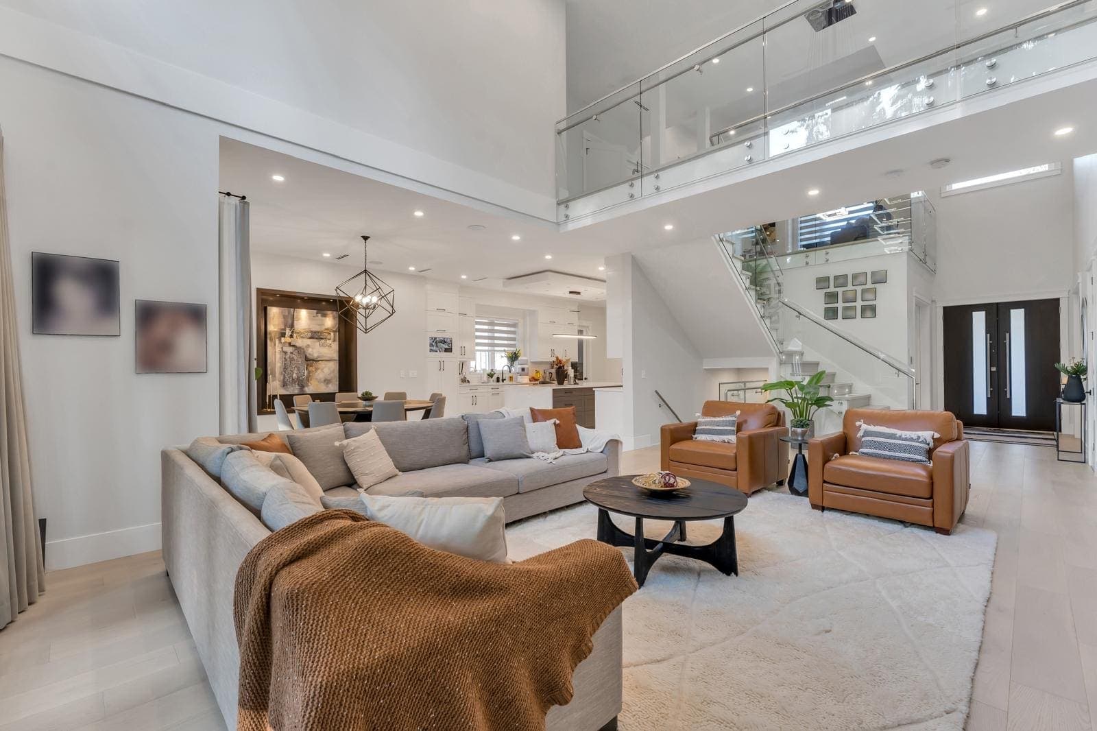 Living room with a linear fireplace and full-height glazing onto the forest — The Greenbelt House