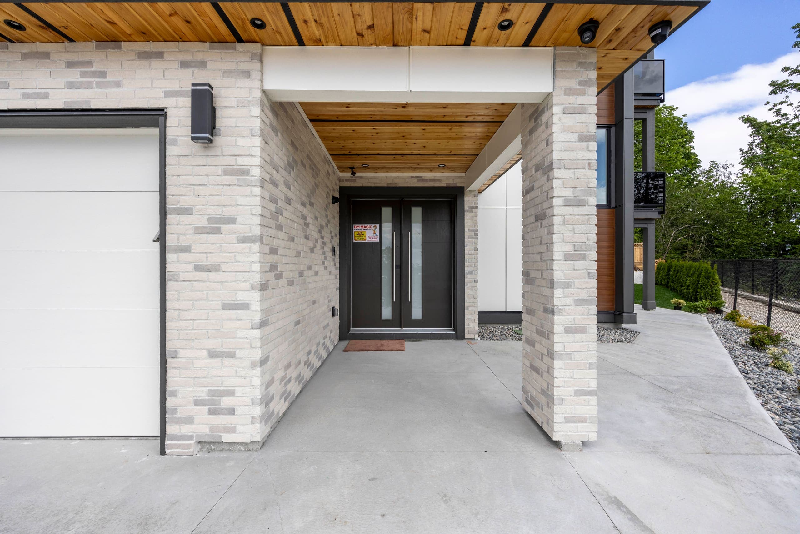 Entry portico in stone with a cedar-lined soffit — The Monashee House