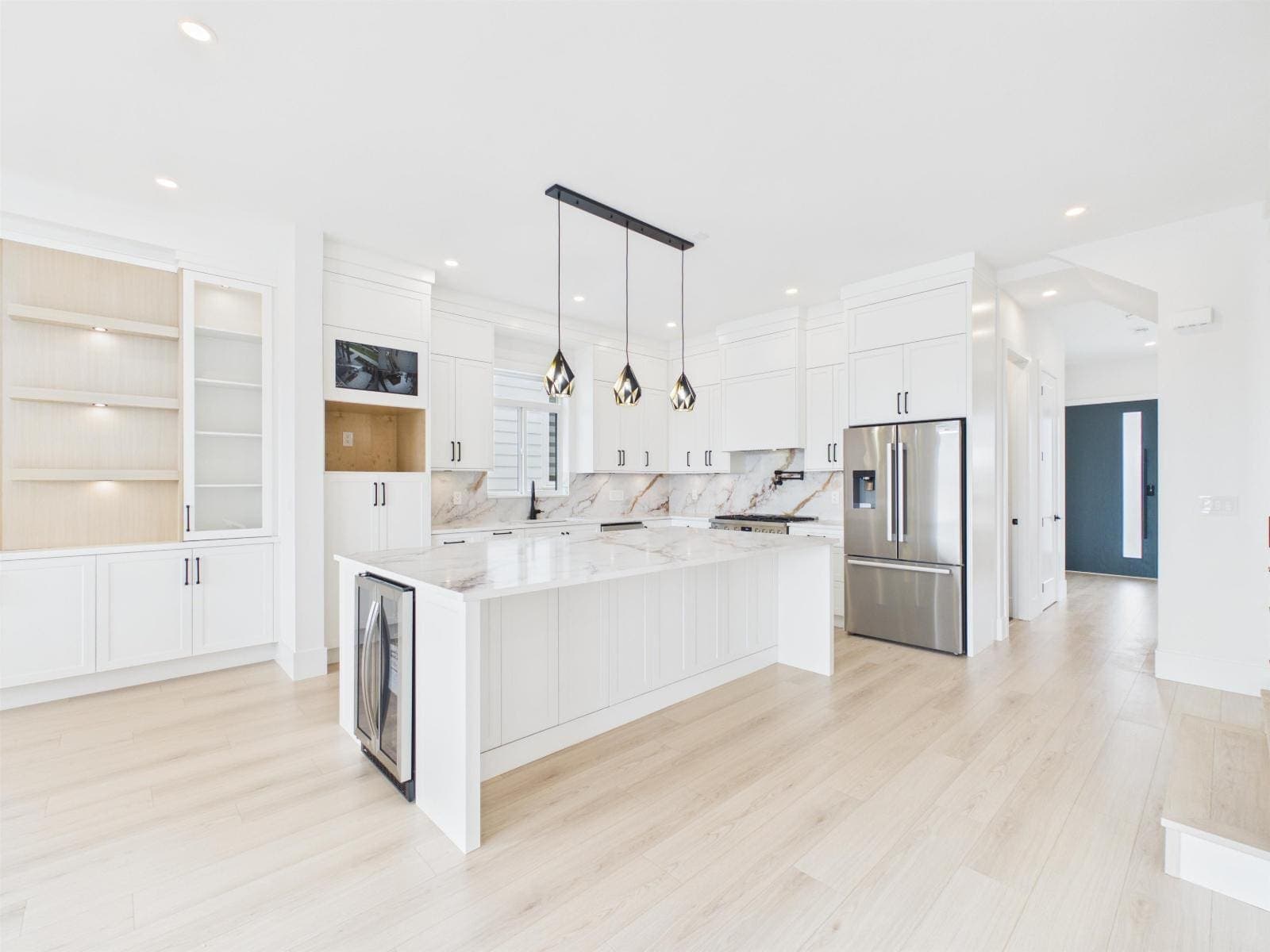 Kitchen with a waterfall island and pendant lighting — The Pacific Douglas Duplex