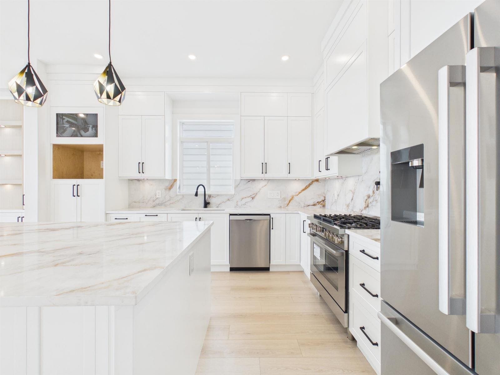 Kitchen detail — gas range against a marbled slab backsplash — The Pacific Douglas Duplex