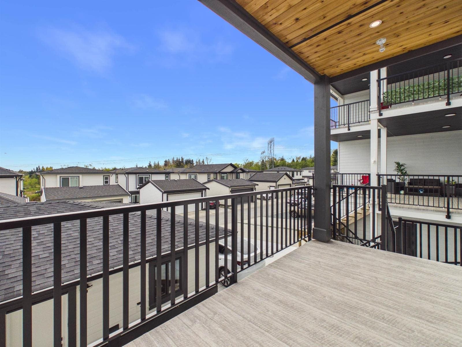 Covered balcony with a cedar soffit, facing south — The Pacific Douglas Duplex