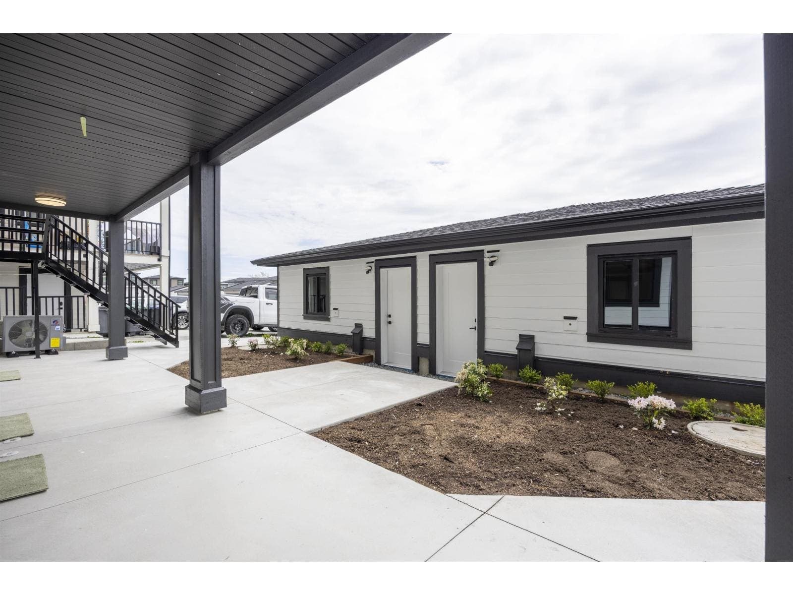 Covered patio at the lower level — The Pacific Douglas Duplex