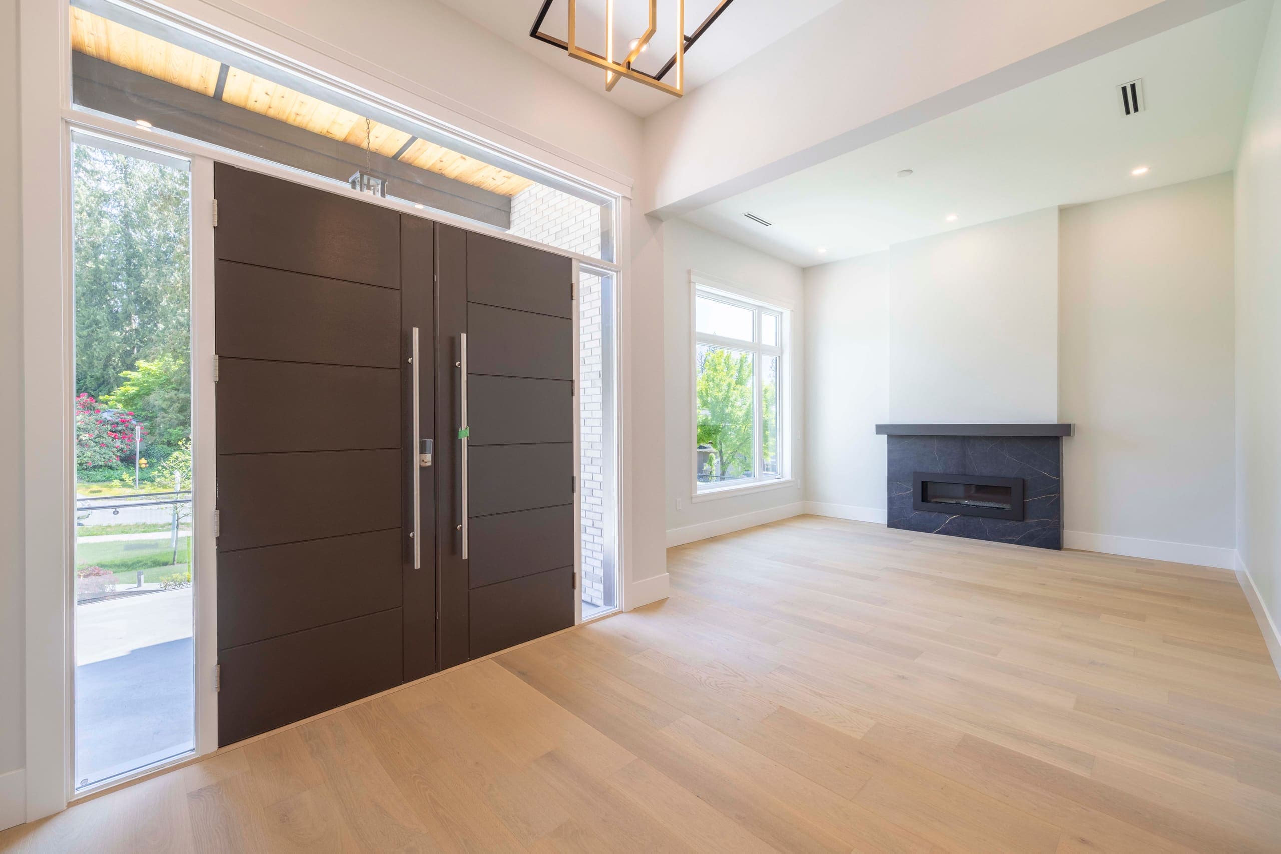 Entry with tall double doors opening to the living room — The Ridge House