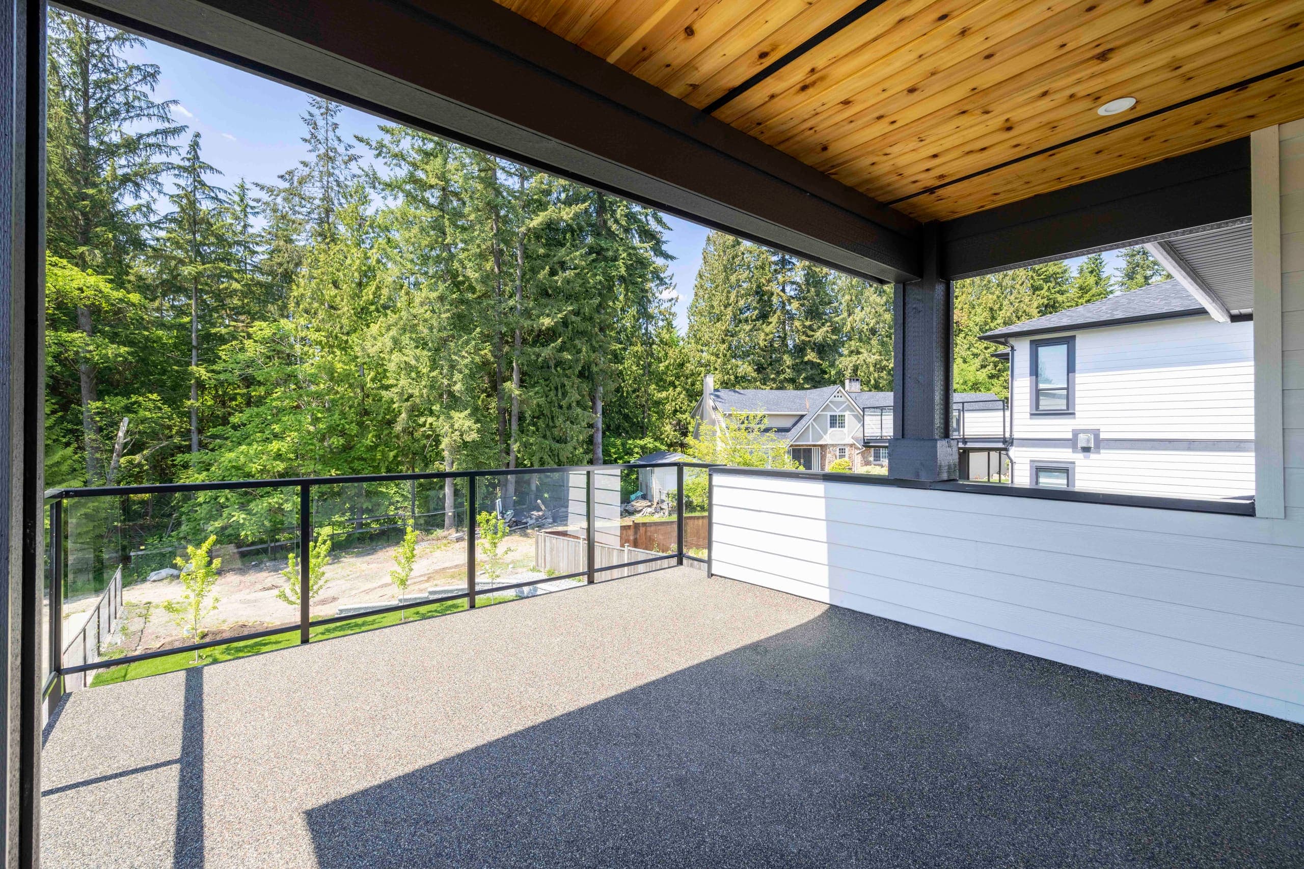 Covered deck with a cedar soffit, open to the trees — The Ridge House
