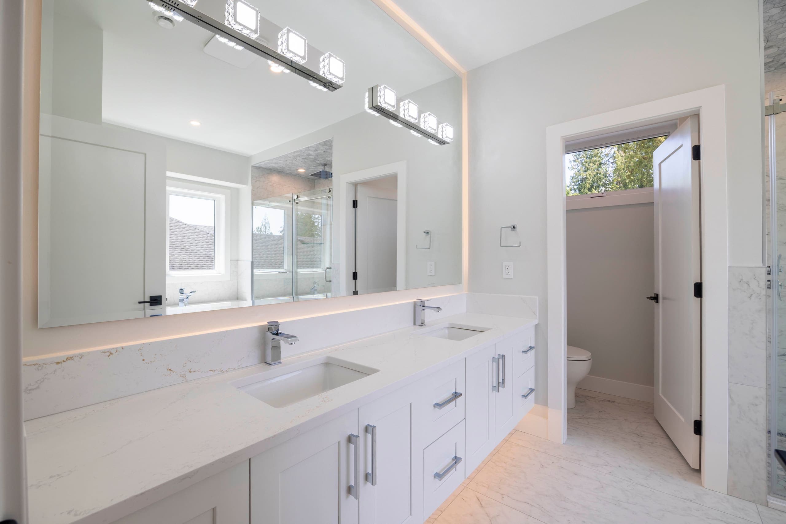 Twin vanities in the principal ensuite — The Ridge House