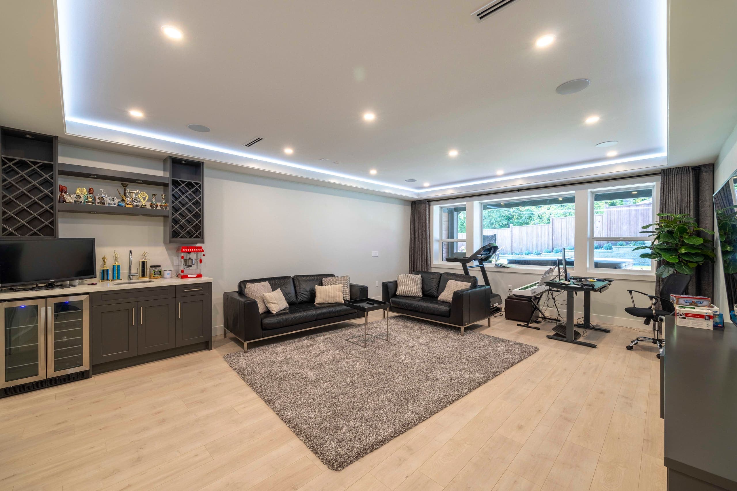 Lower-level media room with a wet bar — The Ridge House